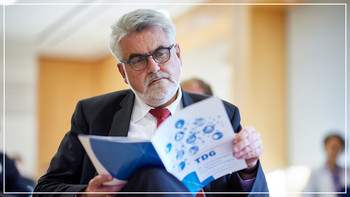 Minister Willingmann hält den aktuellen  TDG-Trendreport aufgeschlagen in seinen Händen